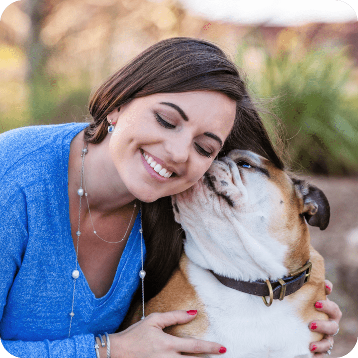 Happy pet owner embracing her lovely dog, illustrating the peace of mind and joy that comprehensive pet insurance provides for both pets and their families.