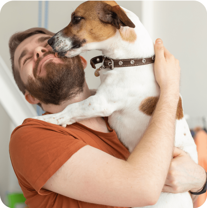 A dog lovingly licking its owner, showing affection and gratitude for the care made possible through its pet insurance.