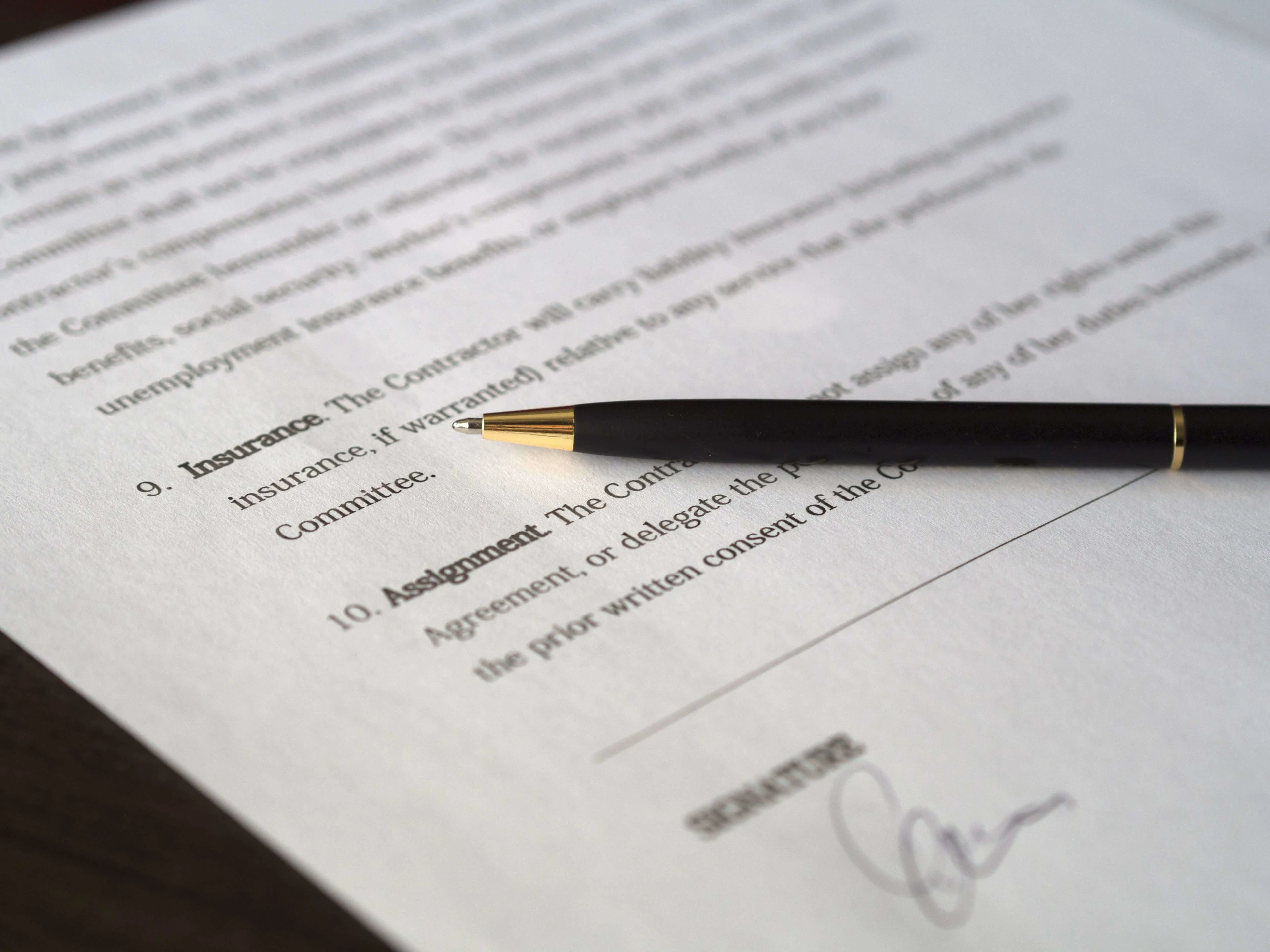 Close-up image of a business contract and pen, signed and ready for agreement.
Photo by Pixabay: https://www.pexels.com/photo/black-pen-placed-on-white-paper-261679/