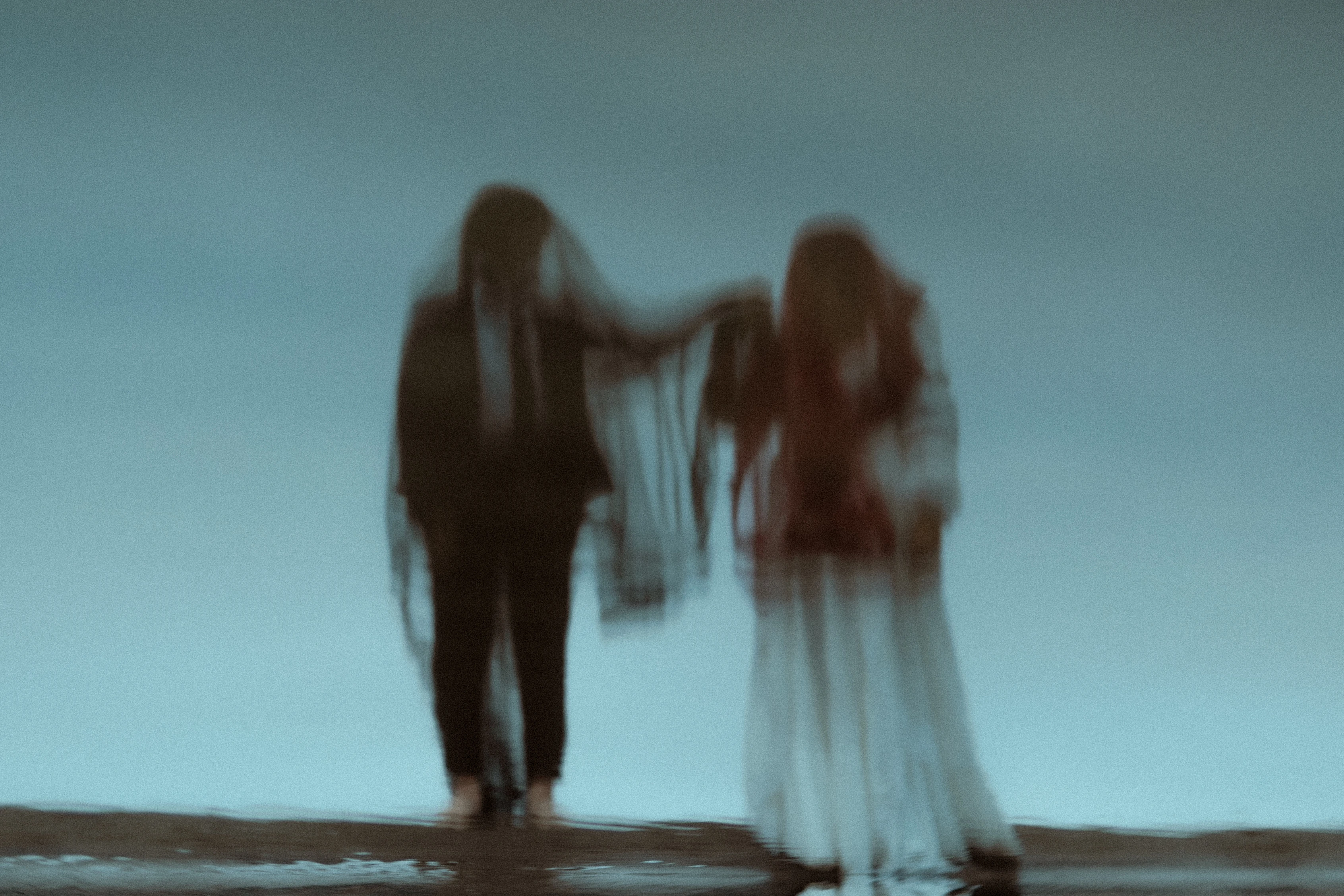 A couple photographed for a styled shoot in Oregon with an out of focus eerie feel to the image by Milly Baine of The Rose Reflective