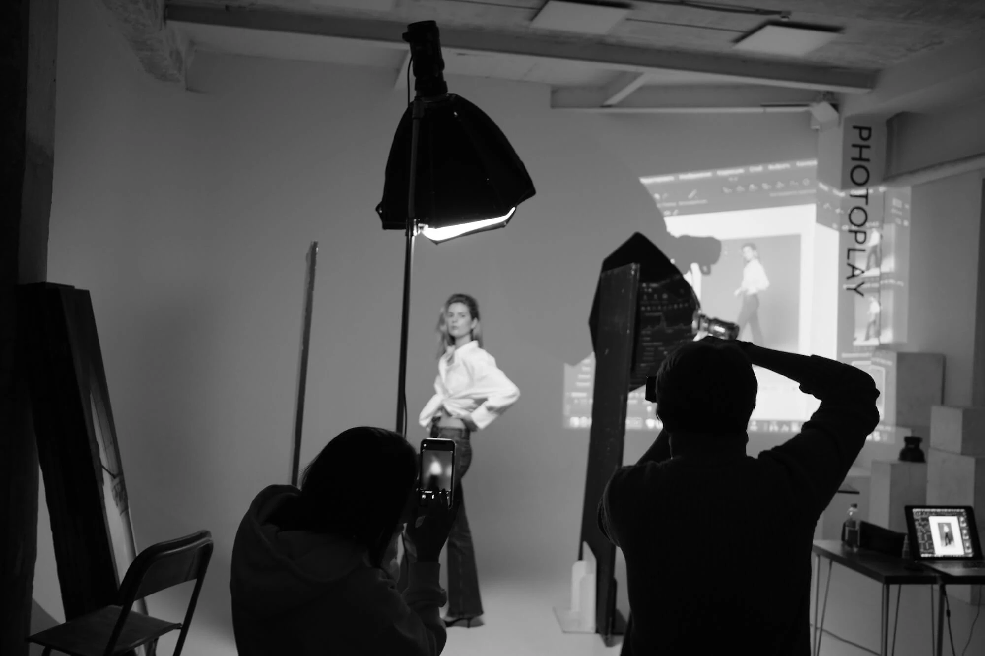 Capturing a professional black and white studio photoshoot with a model and photographers. Photo by Диана Дунаева (Diana Dunayeva)