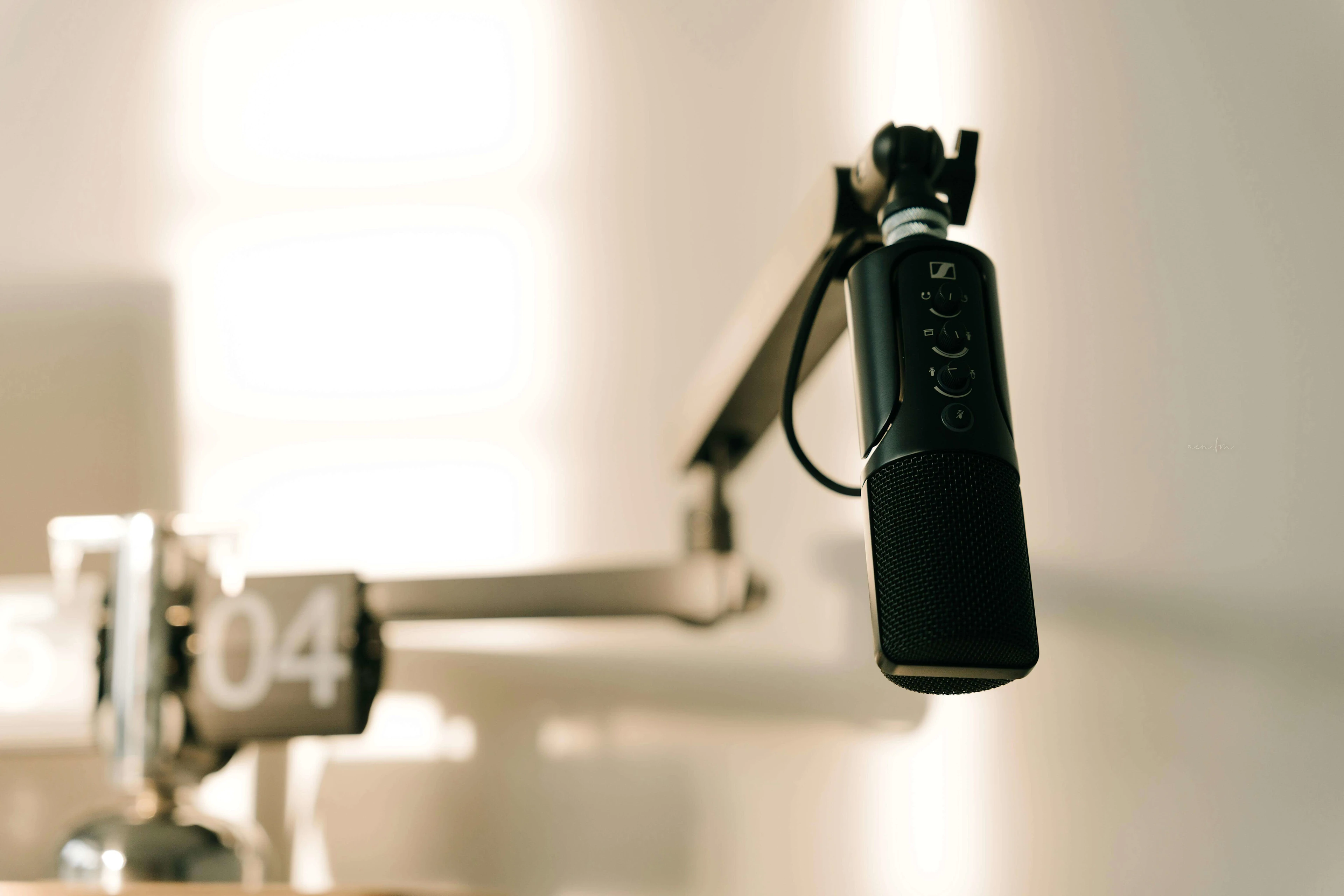 A sleek professional microphone on a boom arm in a minimalist studio.
Photo by Alpha En: https://www.pexels.com/photo/close-up-of-professional-microphone-in-studio-setting-31213674/