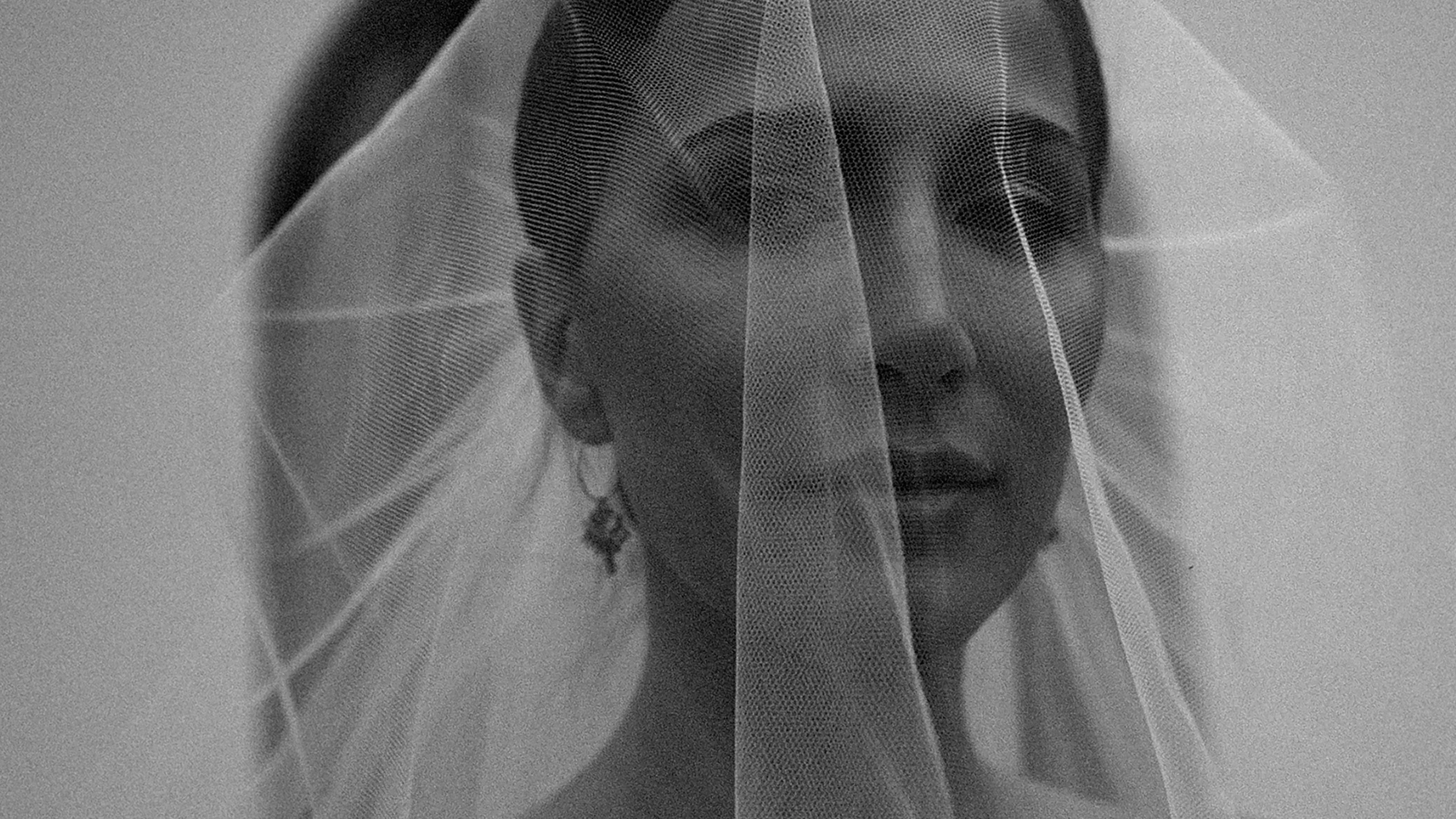 Black and white bridal portrait featuring a bride behind a veil, showcasing professional wedding photography enhanced by Narrative’s AI photo culling and editing workflow for photographers.