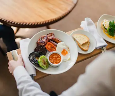 Start your morning with a full Irish breakfast alongside lighter options and baked goods. Later, enjoy a hot buffet of hearty dishes, including rich curries, slow-cooked meats, and seasonal vegetarian options.