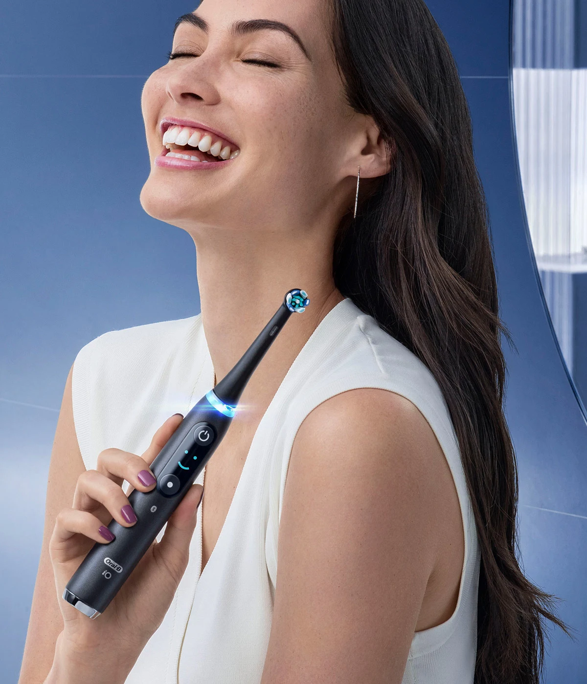 Happy Female Holding Orchid Purple Oral-B iO Electric Toothbrush 