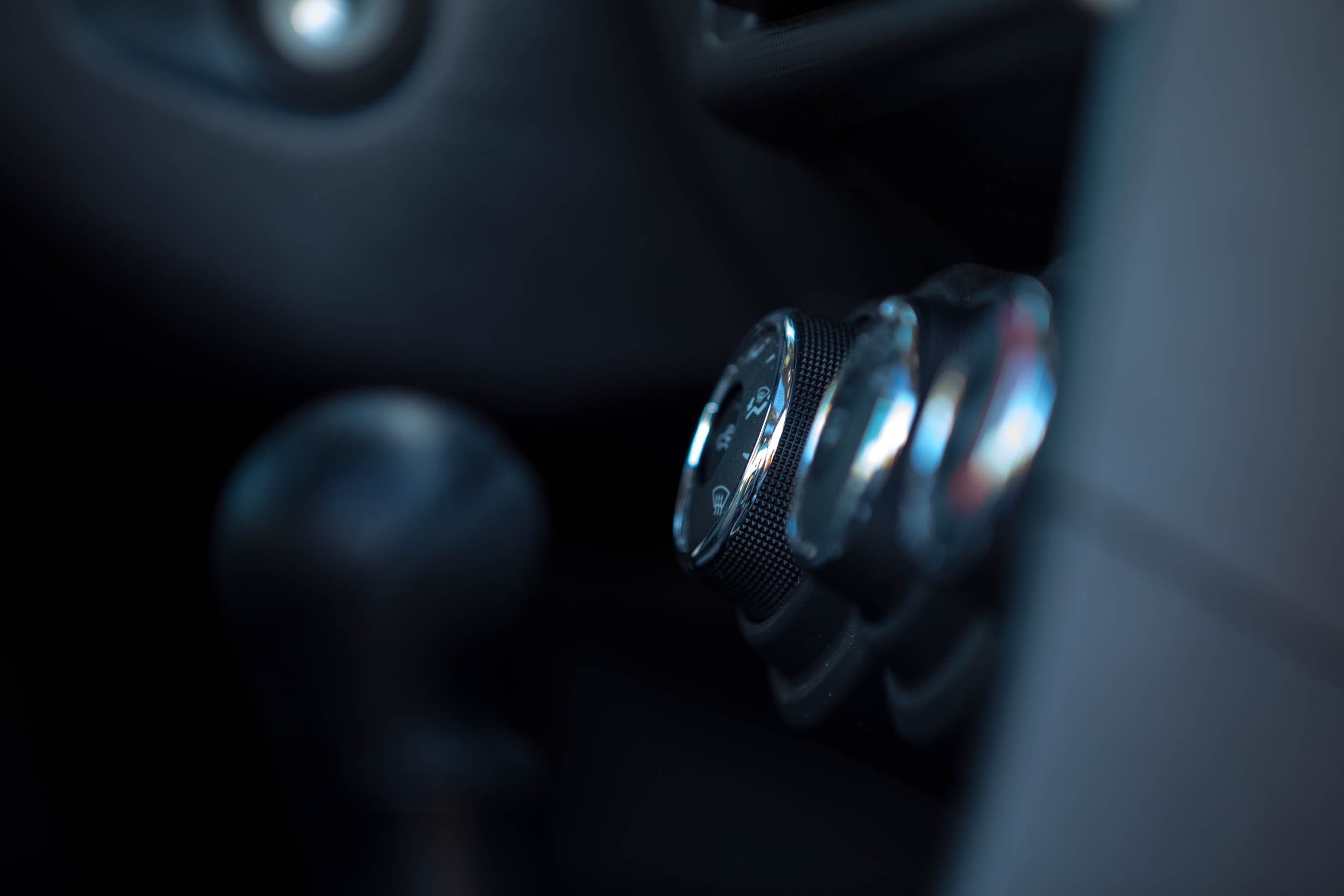 AC dials in car with shift knob in the foreground