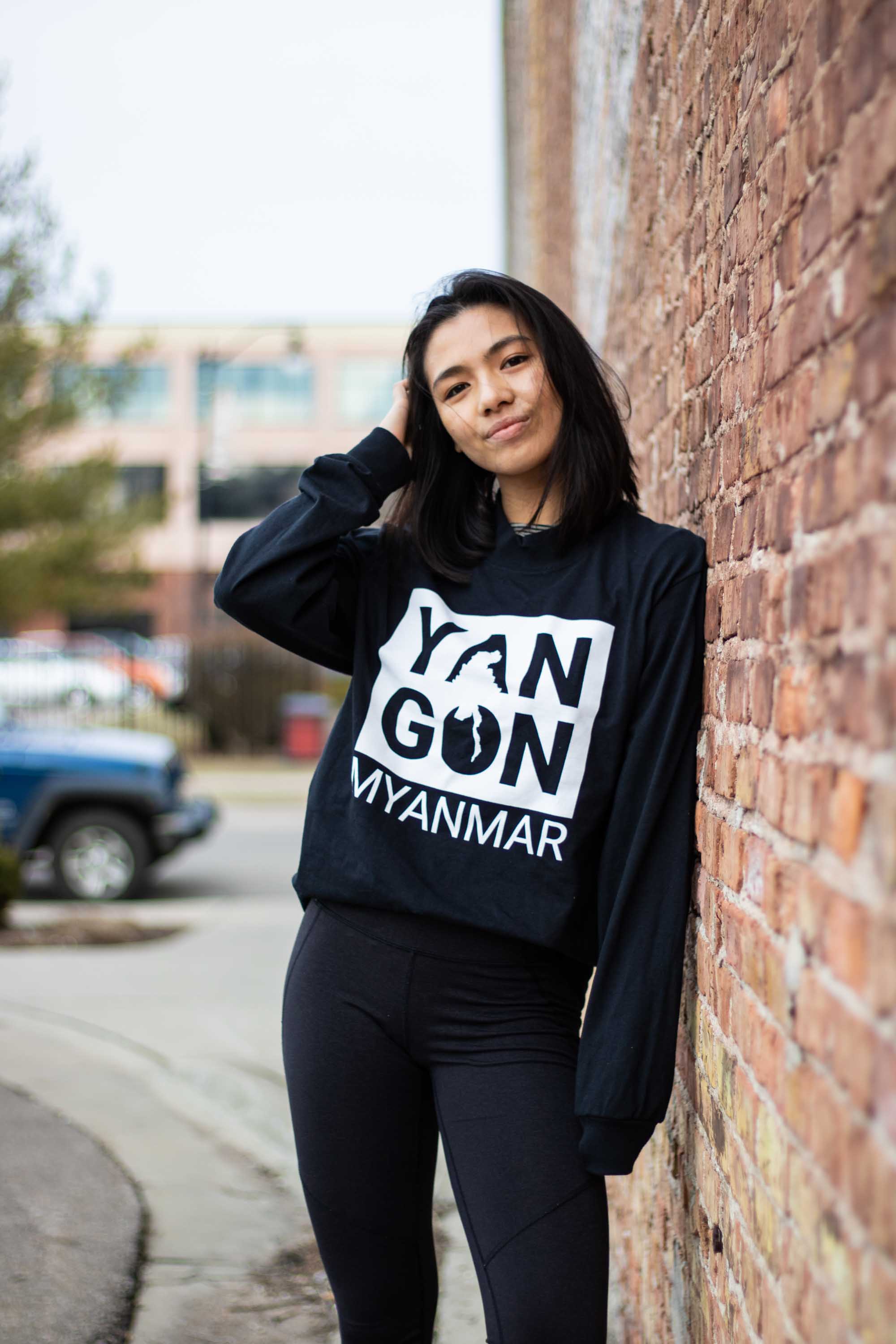 A woman leaning on bricks