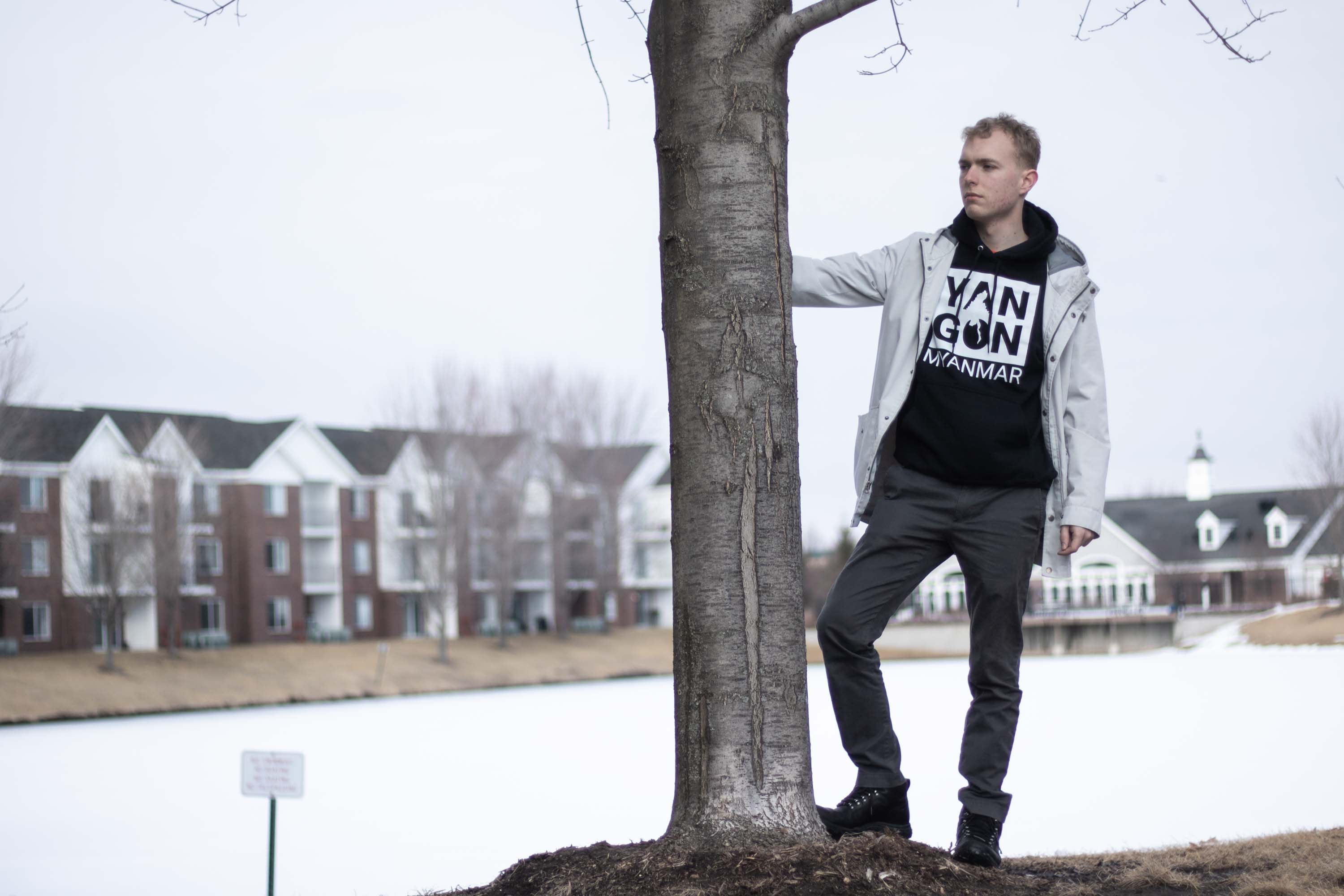 Person holding on tree truck