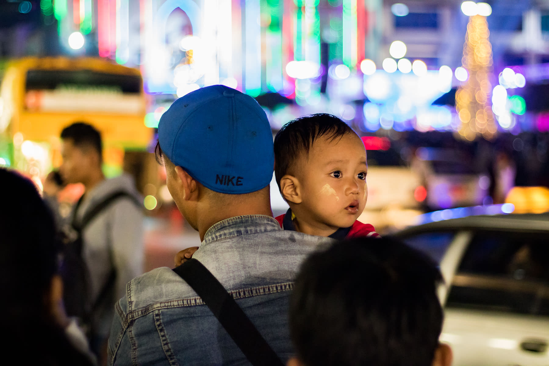 A young child held by a person