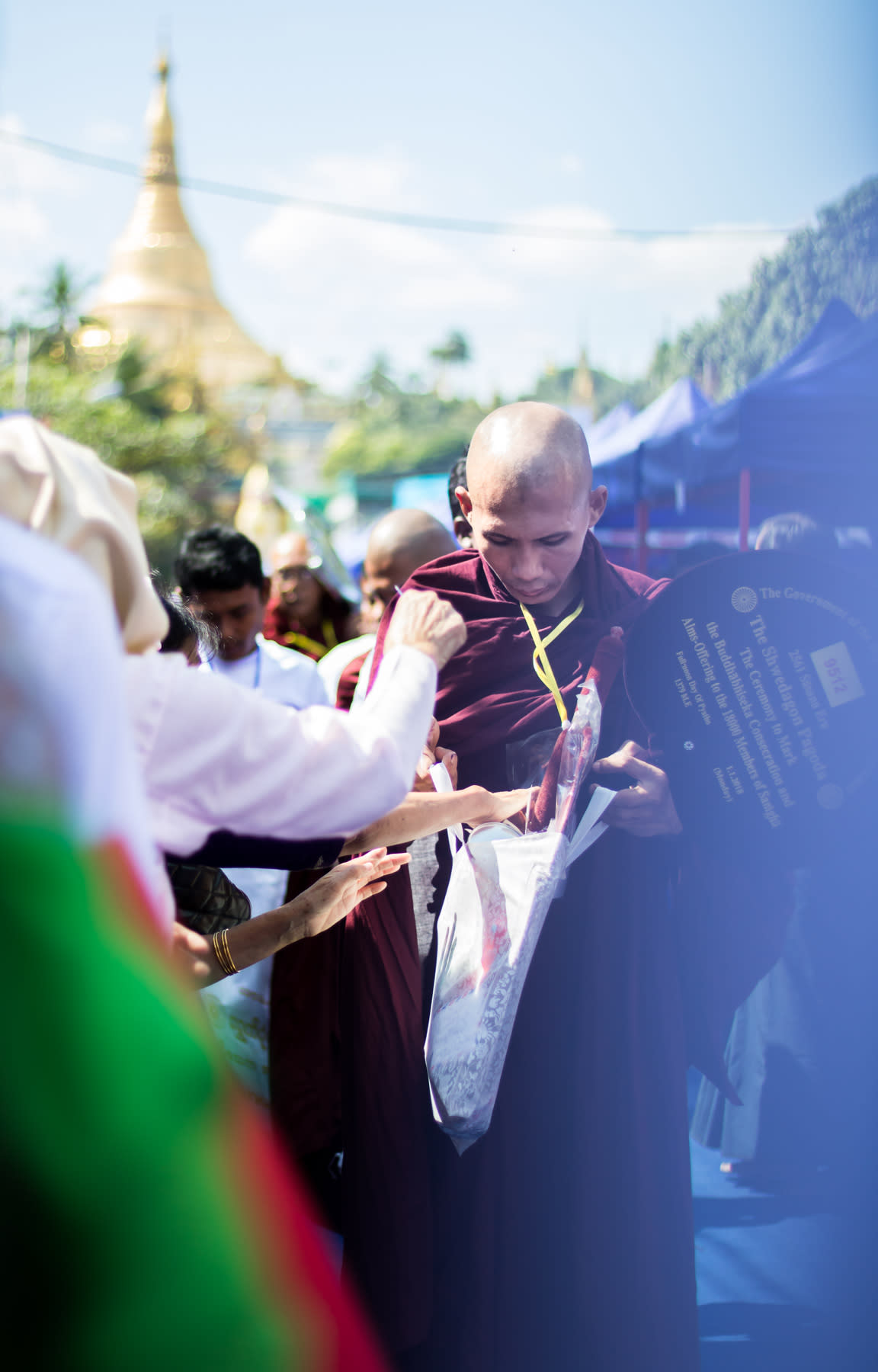 Monk receiving donation in front of Shwedagon Pagoda