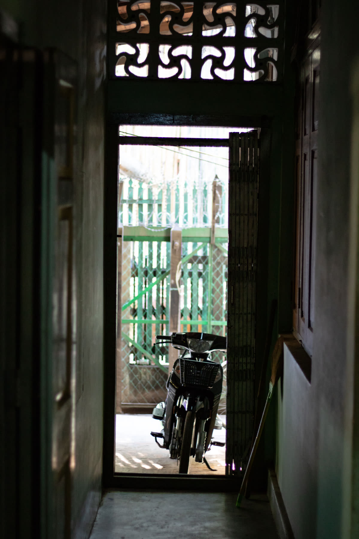 A motorbike leaning on a doorway