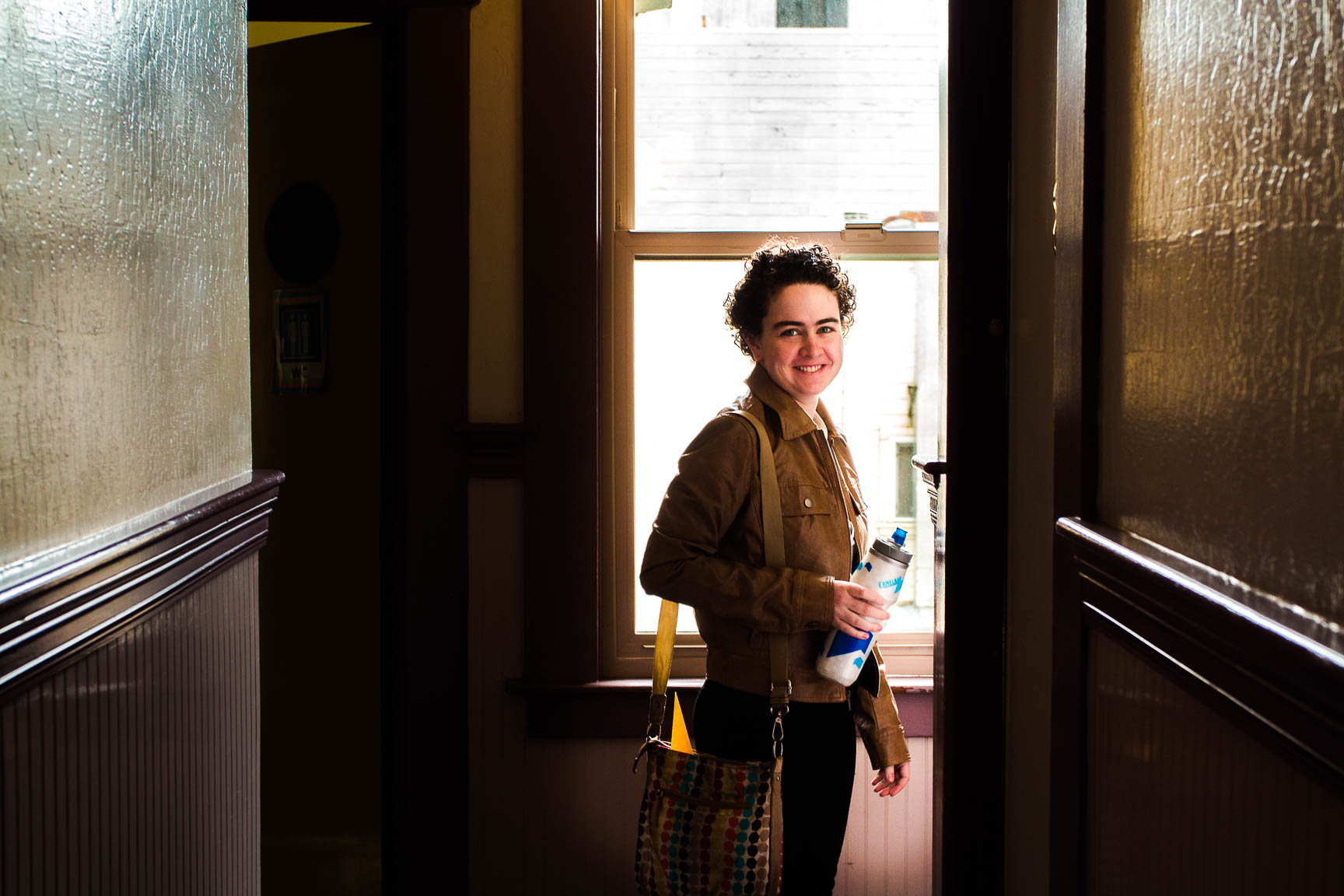 Person smiling at camera in the hallway