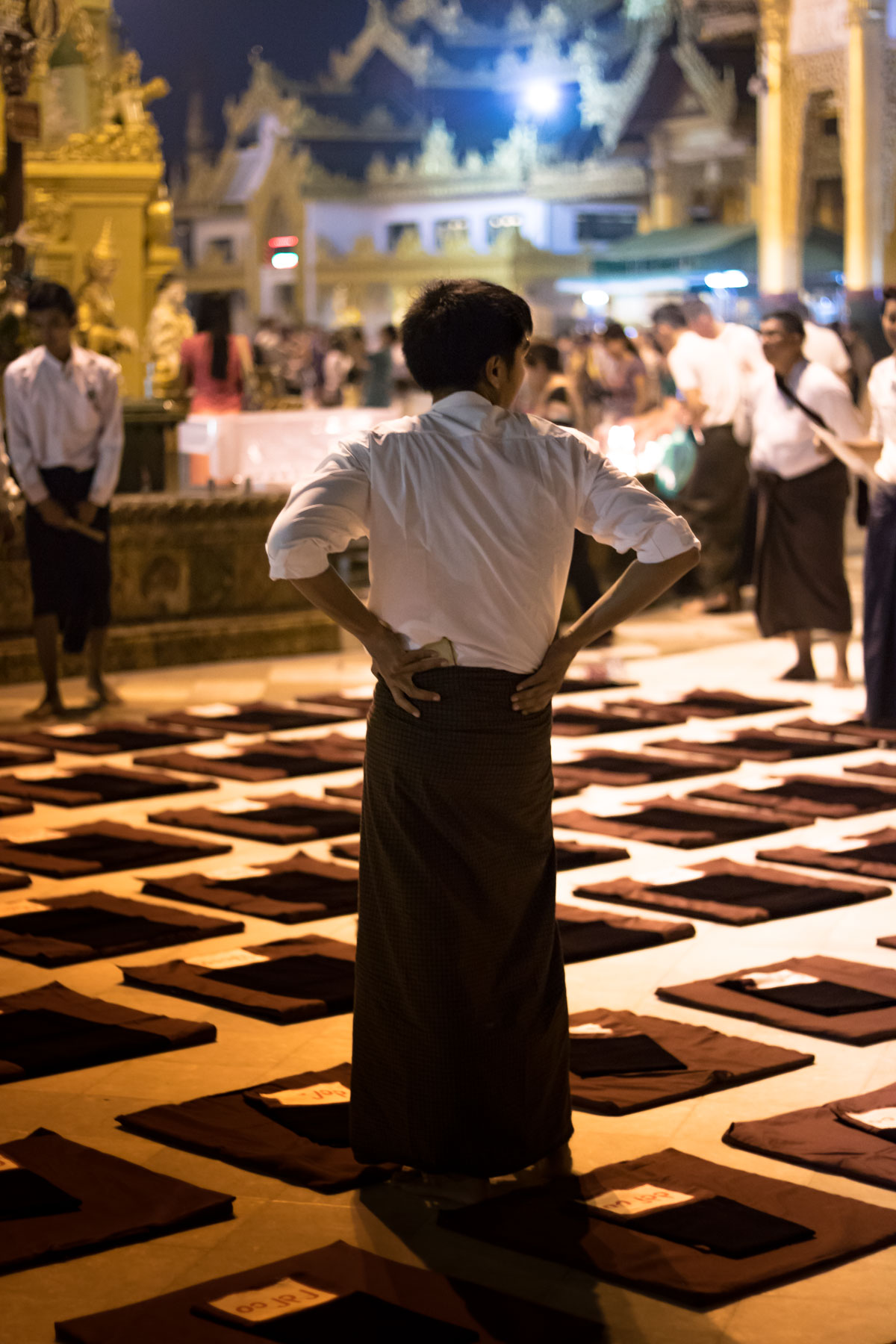 The back of a person standing a floor of garments