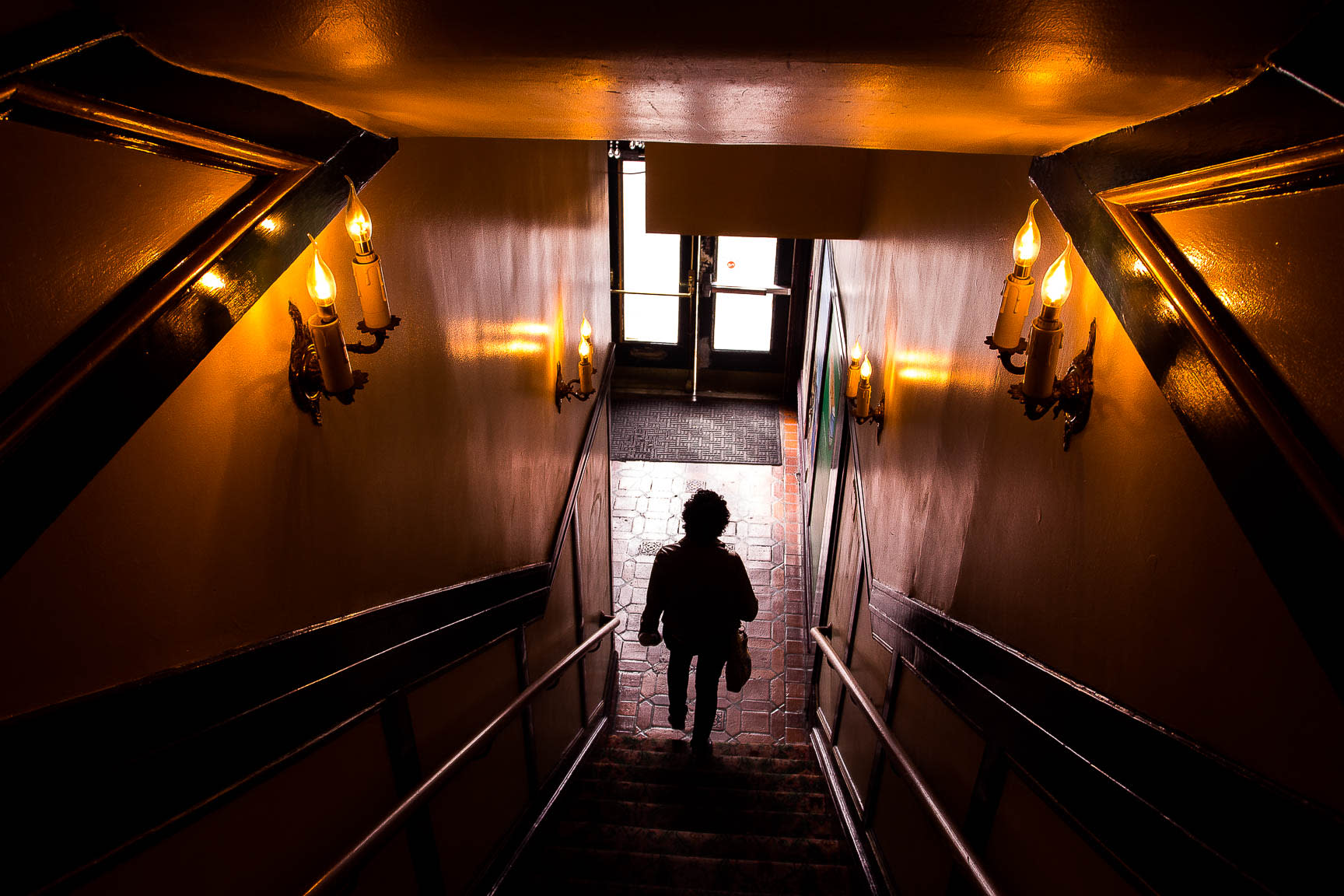 Person walking down stairs of a hallway