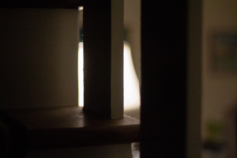Silhouette of staircase in front of lamp
