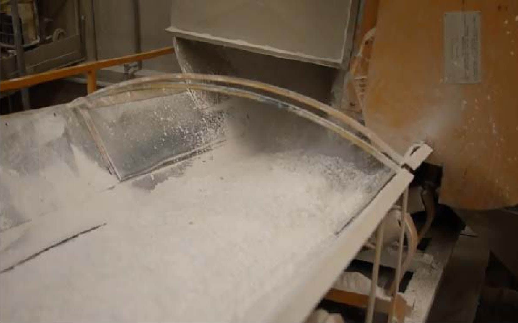 Mixing marble powder, resin and the larger stones to make a marble slurry that is then cast and cut into Marmoreal.