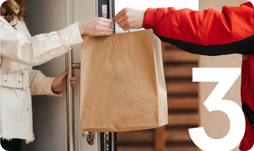 Delivery driver handing a paper bag to a customer at the door, illustrating convenient food delivery and on-demand order fulfillment.