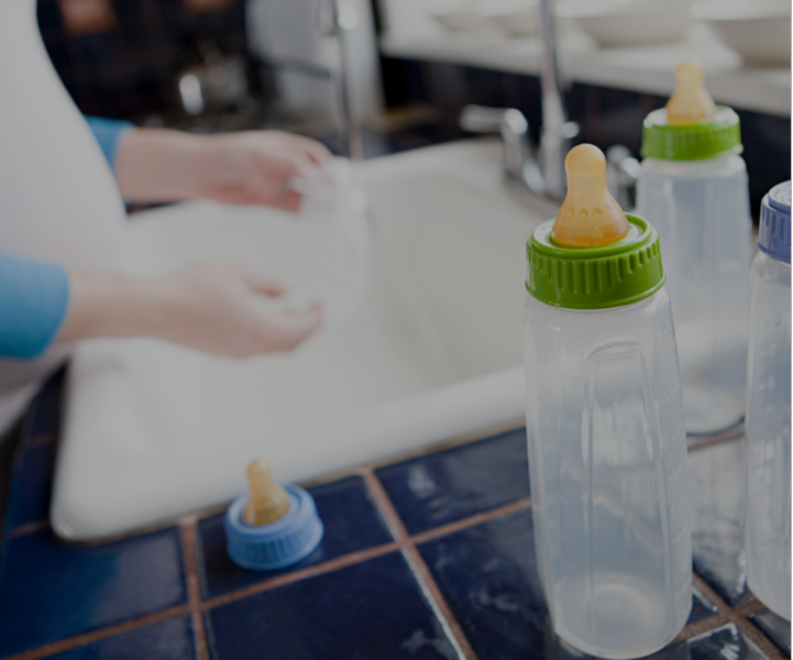 Shops washing baby bottles with dawn