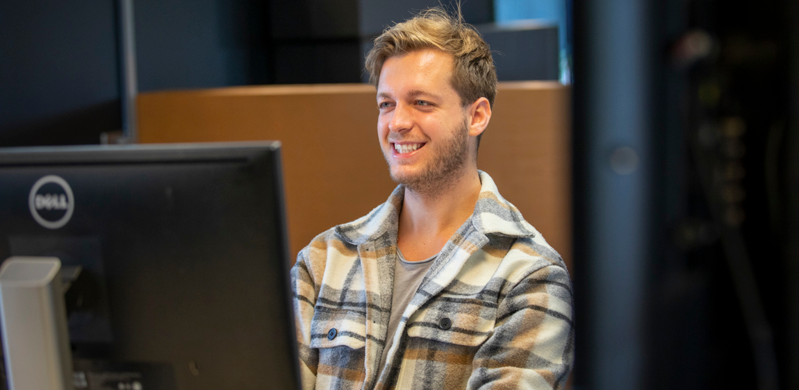 Een project manager (Márton) heeft het naar zijn zin terwijl hij op kantoor werkt.