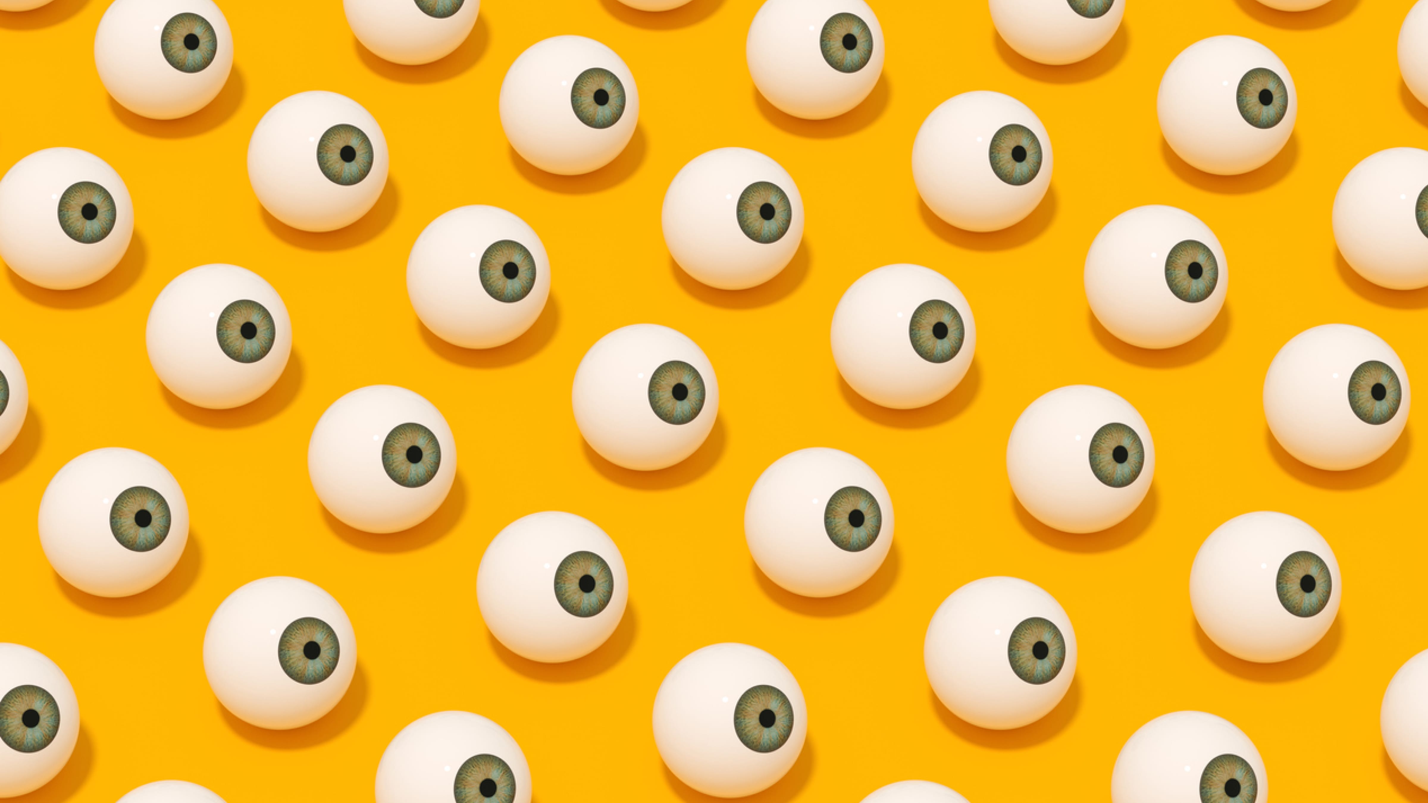 Een gele achtergrond met getekende oogballen 
