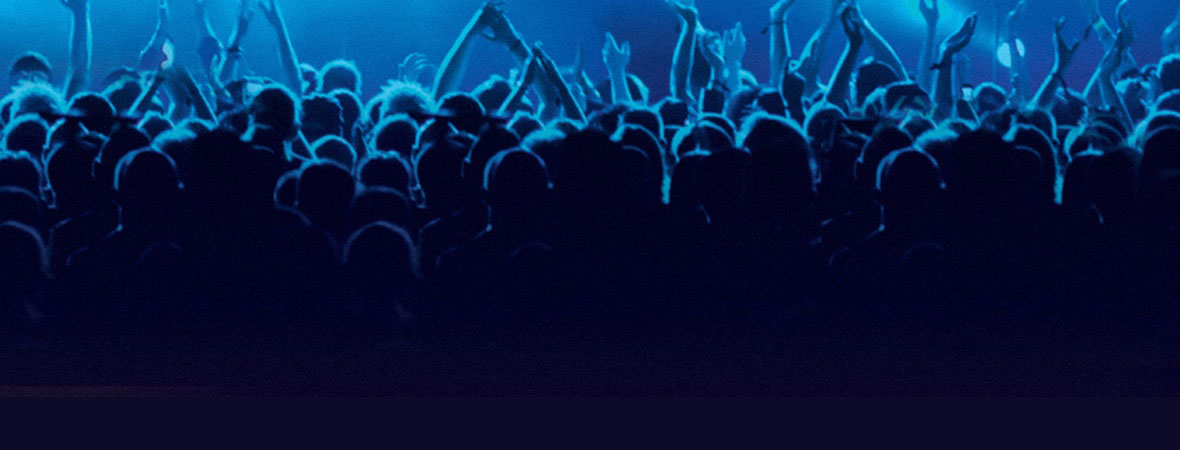 crowd A crowd of people in a live concert with their hands in the air