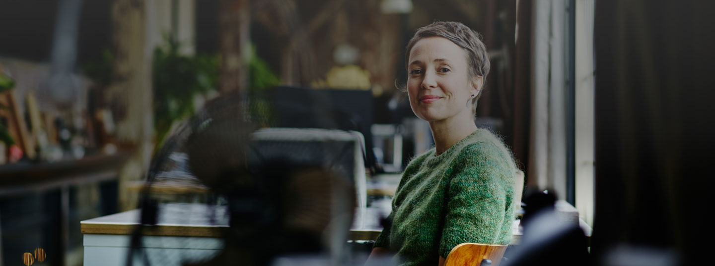 A woman sitting on a chair smiling 