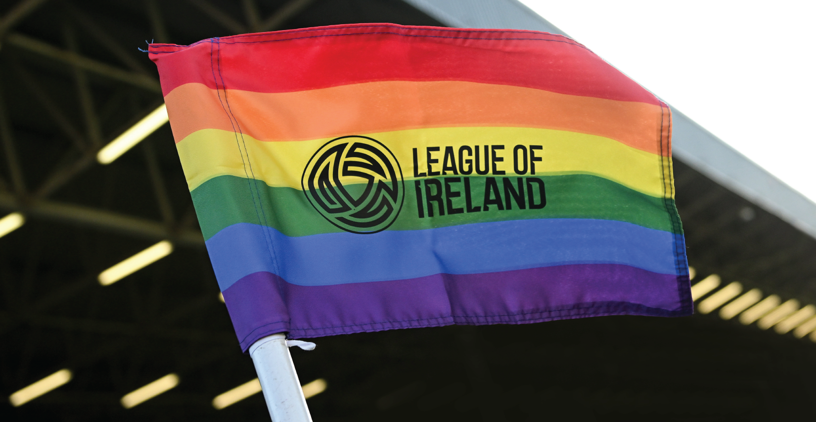 The League of Ireland logo overlaid on the LGBTQ flag