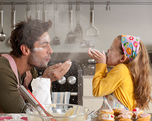 A father and daughter playing with flour