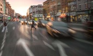 A view of cars on the road, blurred as in motion.