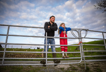 You can still switch energy suppliers Dad and girl standing on a gate