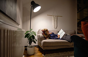 Smart Hints and Tips: Lighting IE HE (resize) A woman reading a book on a sofa