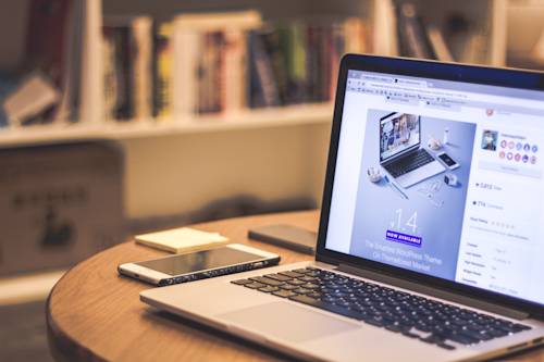 Laptop and phone on desk with wordpress website theme