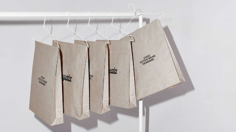 Coat rack with EYDA product bags on hangars