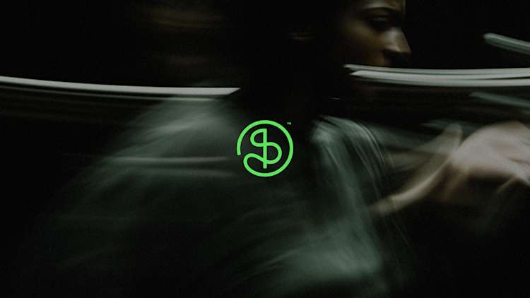 A bright neon green circular logo containing stylized "OS" letters with a trademark symbol, set against a dark background with smoky green motion blur effects.