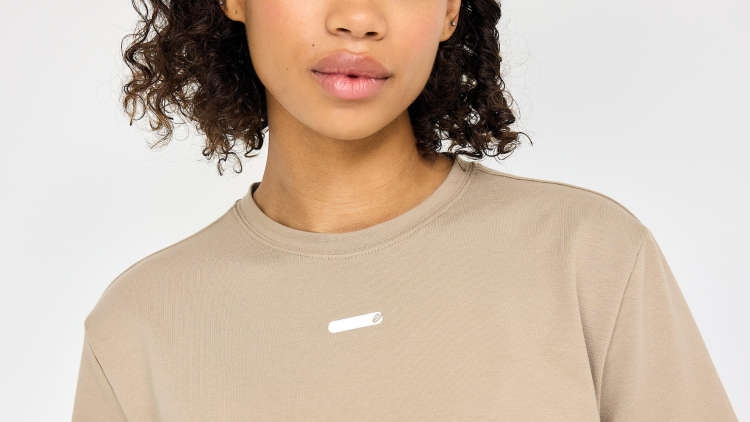 Image of woman wearing a beige EYDA shirt