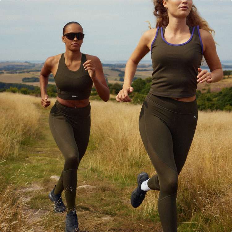 Two runners wearing olive green EYDA clothing