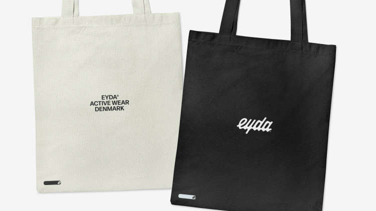 Light and dark versions of EYDA branded totes