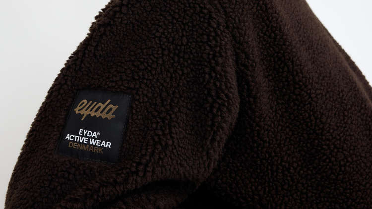 An EYDA branded dark fleece jacket