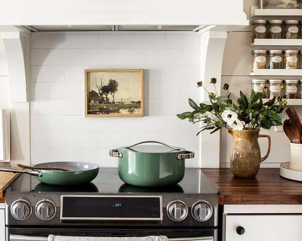 green dutch oven sitting on a stove