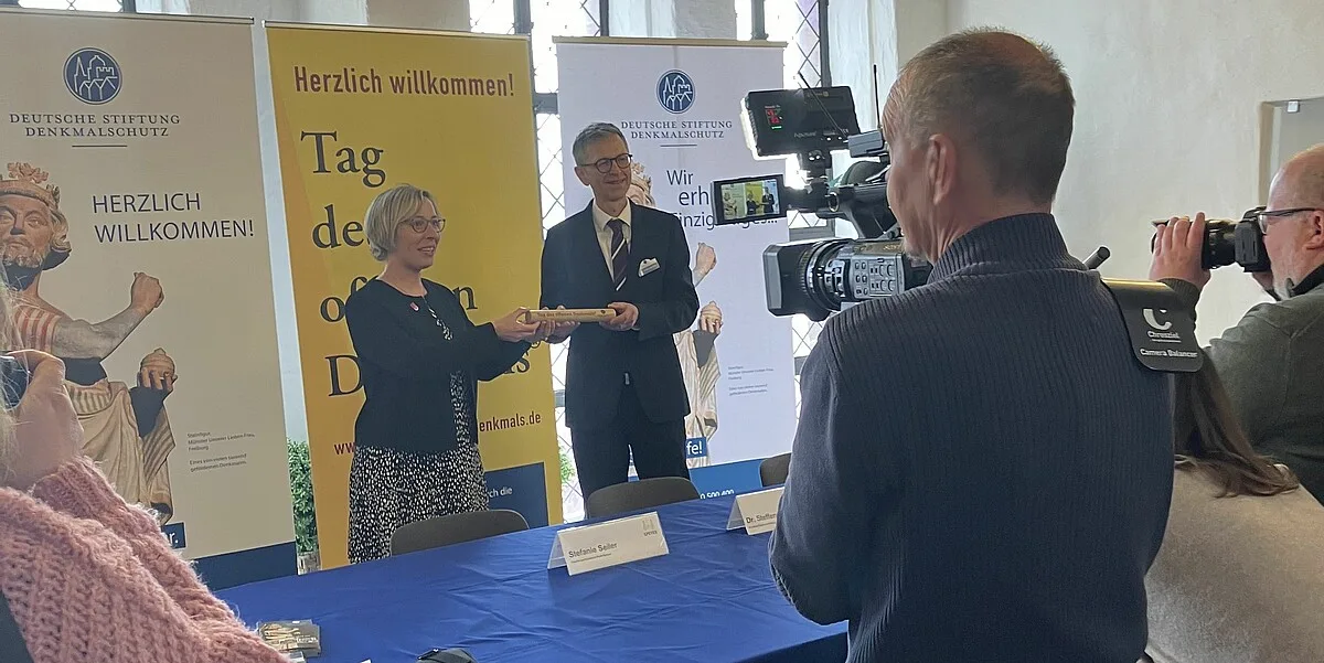 Stefanie Seiler, Oberbürgermeisterin von Speyer, und Dr. Steffen Skudelny, Vorstand der Deutschen Stiftung Denkmalschutz, bei der Weitergabe des Staffelstabs der Eröffnungsstadt