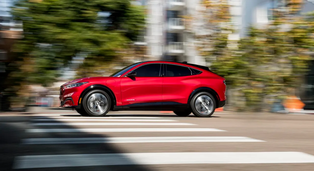 Red Mustang Mach-E driving on a street