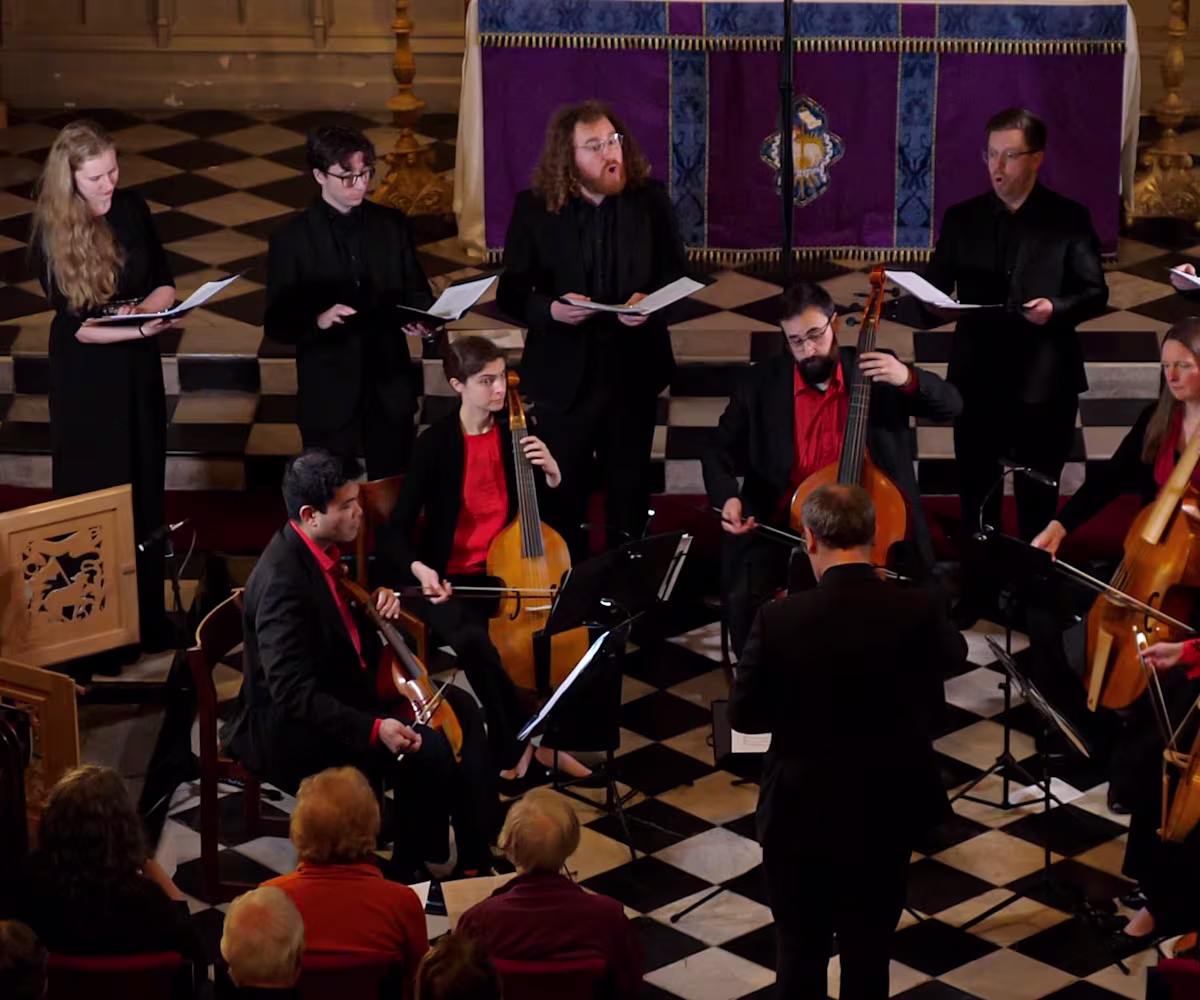 A Heavenly Harmony Early music viol consort Chelys Consort and Vespri singers performing in a church with distinctive chequered flooring