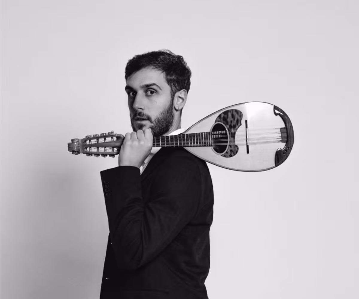 Vivaldi Mandolin & Violin Concertos a man holding a mandolin over his shoulder in black and white