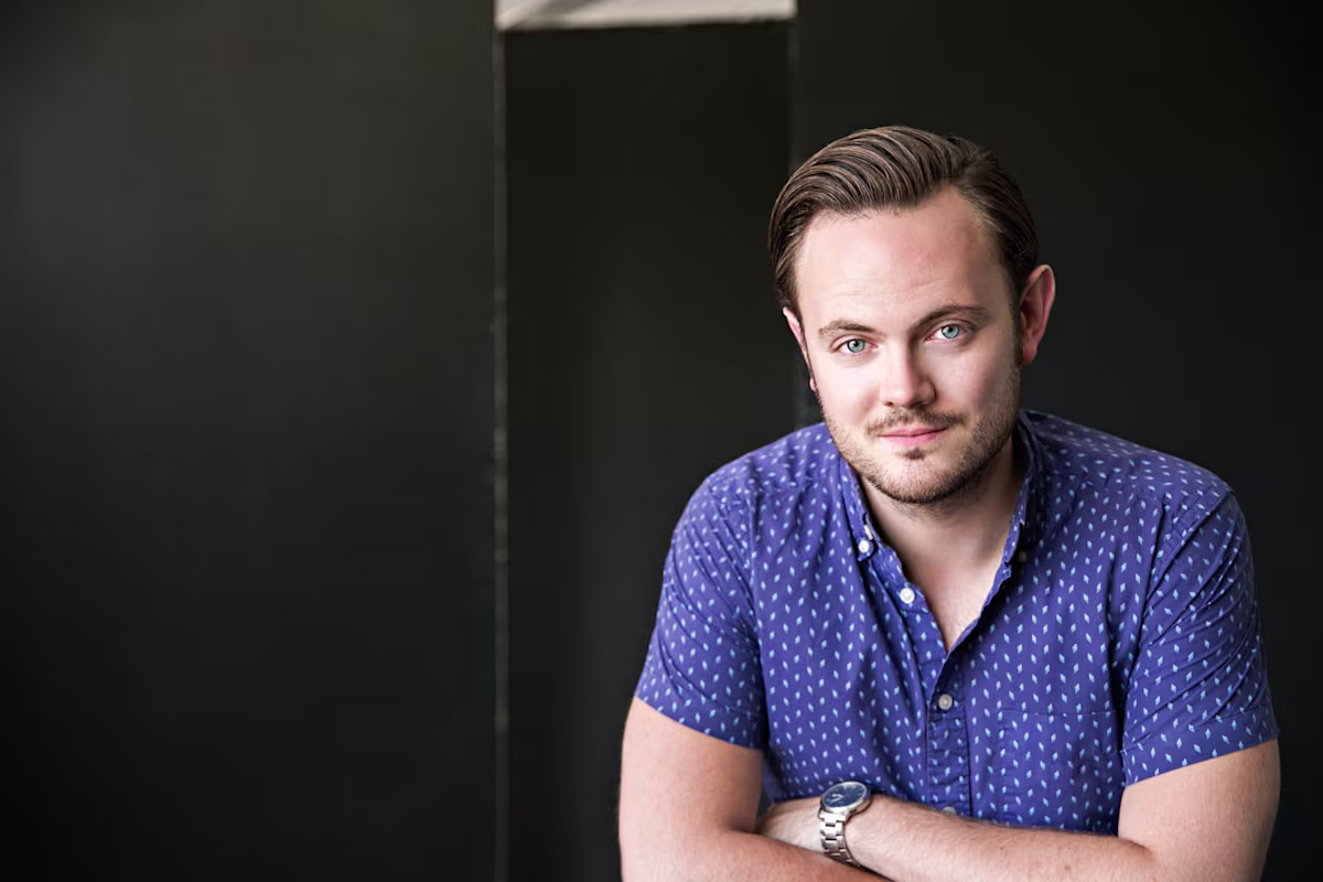 nick pritchard tenor headshot in blue shirt by nick hames