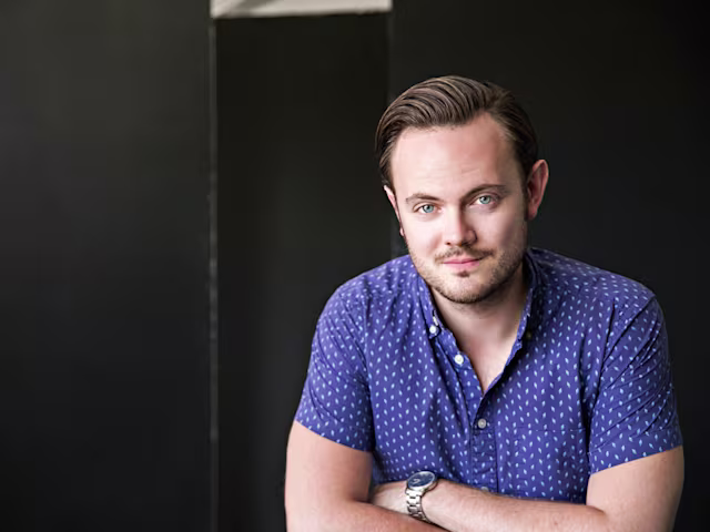 Schubertiade at Canonteign nick pritchard tenor headshot in blue shirt by nick hames
