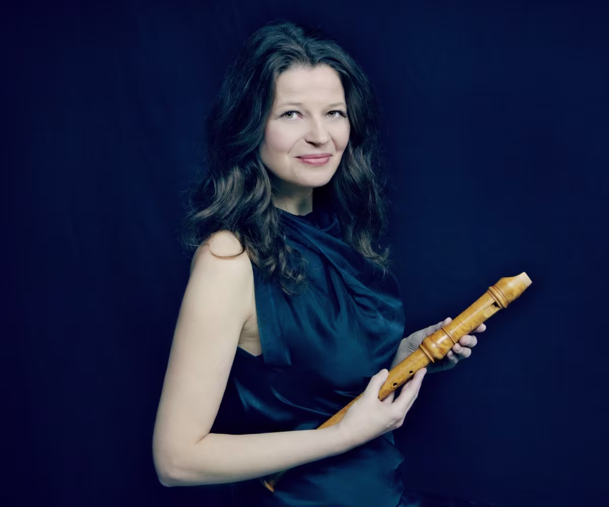 London International Festival of Early Music recorder player dorothee oberlinger holding a wooden recorder on a dark background