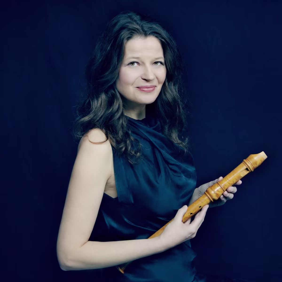 London International Festival of Early Music recorder player dorothee oberlinger holding a wooden recorder on a dark background