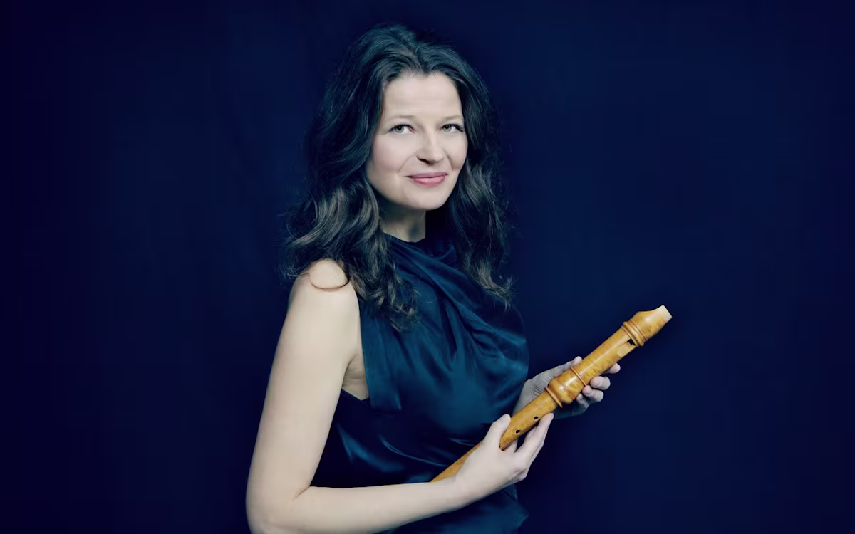 London International Festival of Early Music recorder player dorothee oberlinger holding a wooden recorder on a dark background