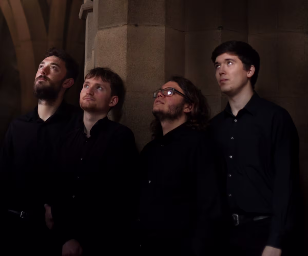 A Medieval & Modern Late-Night Encounter four members of iuchair in a church wearing all black