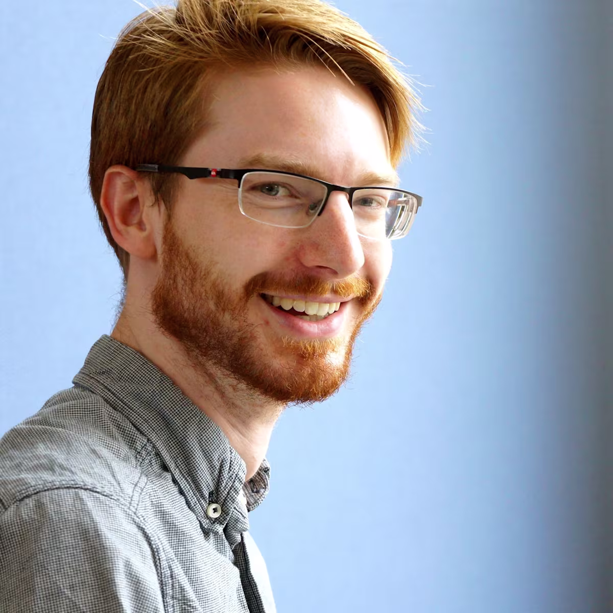 Neil T. Smith: Hidden Polyphony Profile headshot of Neil Tòmas Smith with blue background